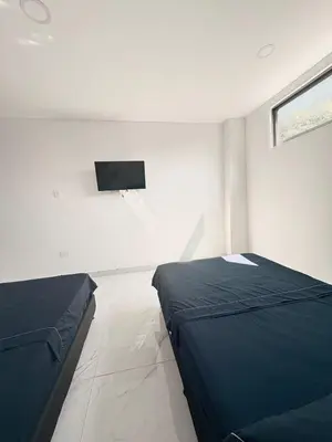 a bedroom with two beds and a flat screen tv at Maru apartamentos #6 in Cartagena de Indias