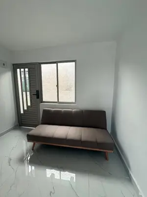 a couch sitting in a room with a window at Maru apartamentos #6 in Cartagena de Indias