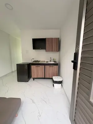 a kitchen with a sink and a tv on the wall at Maru apartamentos #6 in Cartagena de Indias