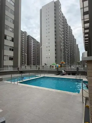 a swimming pool in a city with tall buildings at Exclusivo apartamento en ciudad Mallorquin in Barranquilla