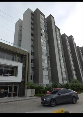 a car parked in front of a large building at Exclusivo apartamento en ciudad Mallorquin in Barranquilla