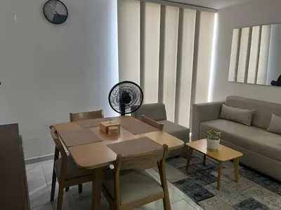 a living room with a table and a couch at Alameda del rio Turpial in Barranquilla