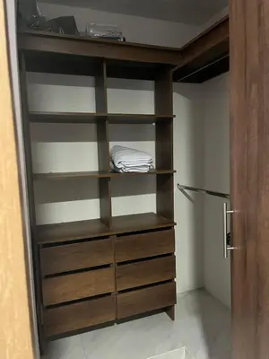 a closet with wooden shelves and a door at Alameda del rio Turpial in Barranquilla