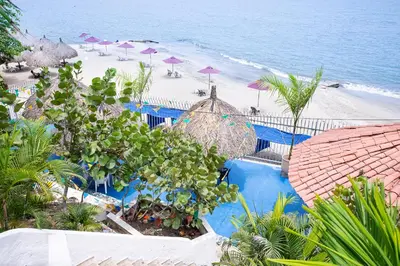 an aerial view of a beach with umbrellas at Hotel Santorini Casablanca Resort in Santa Marta
