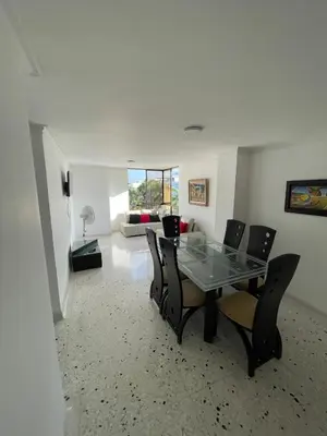 a dining room with a glass table and chairs at Apartamento en el Norte a 5 Minutos de Buenavista in Barranquilla