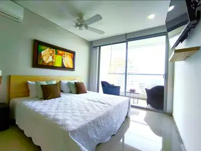 a bedroom with a bed and a large window at Incredible apartment in Cartagena a few meters from the Sea in Cartagena de Indias