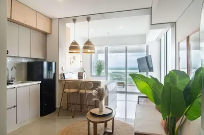 a kitchen with a large window and a table at Elegant Beachview 1BR with Balcony in Crespo in Cartagena de Indias