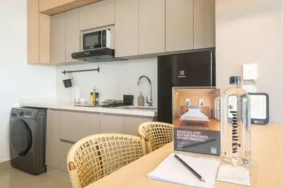 a kitchen with a table with a bottle on it at Elegant Beachview 1BR with Balcony in Crespo in Cartagena de Indias