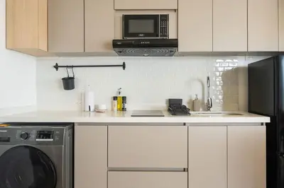 a kitchen with a sink and a microwave at Elegant Beachview 1BR with Balcony in Crespo in Cartagena de Indias