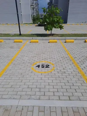 a yellow grate on the ground in a parking lot at A pasos de playa privada Serena del Mar Cartagena in Cartagena de Indias