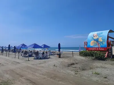 a billboard on a beach with chairs and umbrellas at A pasos de playa privada Serena del Mar Cartagena in Cartagena de Indias