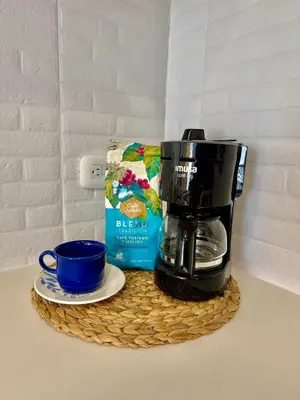 a coffee maker and a cup on a table at A pasos de playa privada Serena del Mar Cartagena in Cartagena de Indias