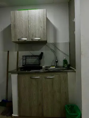a kitchen with wooden cabinets and a sink at Apartamento DUPLEX para Grupos 9 pax in Cartagena de Indias