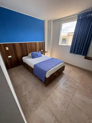 a bedroom with a bed and a large window at Hotel Palma Grande By Origen