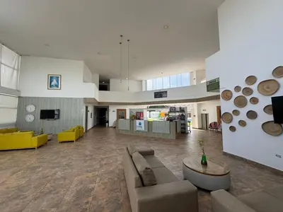 a large living room with couches and a tv at Hotel Palma Grande By Origen