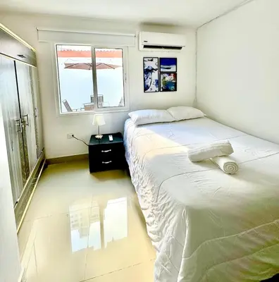 a bedroom with two beds and a window at Apartamento en Cartagena Manga 3 Habitaciones - Bahia in Cartagena de Indias