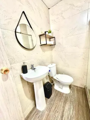 a bathroom with a sink and a mirror and a toilet at Apartamento en Cartagena Manga 3 Habitaciones - Bahia in Cartagena de Indias