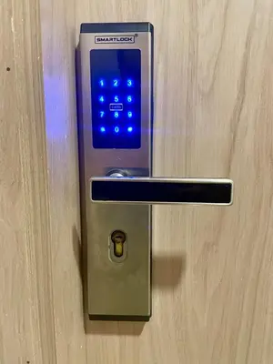 a cell phone is plugged into a lock on a door at Lovely Suite steps away from the airport and beach in Cartagena de Indias