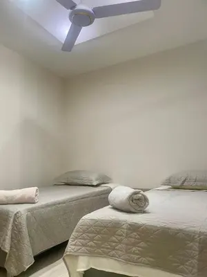 a bedroom with two beds and a ceiling fan at Apto de lujo en Barranquilla in Barranquilla