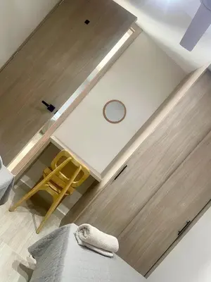 a room with a wooden door and a chair at Apto de lujo en Barranquilla in Barranquilla