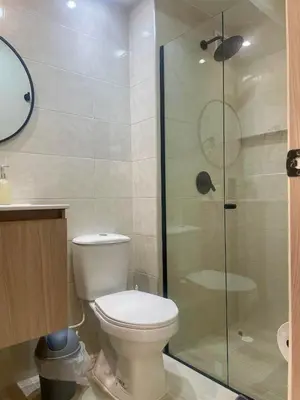 a bathroom with a toilet and a glass shower at Apto de lujo en Barranquilla in Barranquilla