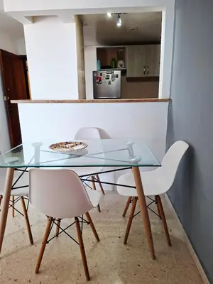 a glass table with two chairs and a pizza on it at Relajación y vista al mar en hermoso apartamento en Cartagena in Cartagena de Indias