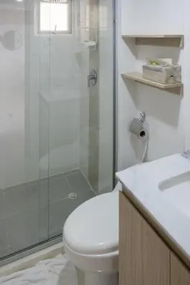 a bathroom with a toilet and a glass shower at Ocean View Apartment - Soho Playa Mendoza in Tubará