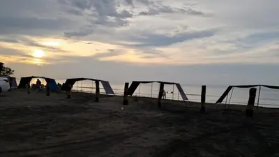 a group of tents on a beach near the water at Ocean View Apartment - Soho Playa Mendoza in Tubará
