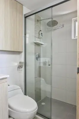 a bathroom with a toilet and a glass shower at Ocean View Apartment - Soho Playa Mendoza in Tubará