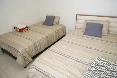 two beds sitting next to each other in a room at Ocean View Apartment - Soho Playa Mendoza in Tubará