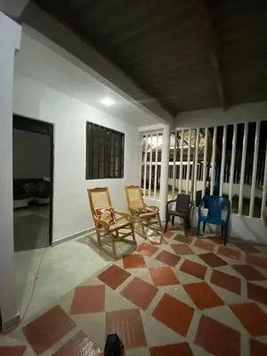 a living room with rocking chairs and a fireplace at Casa Lagomar in Pradomar