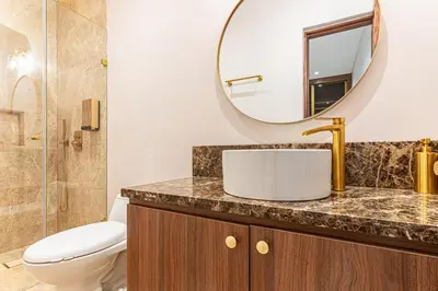 a bathroom with a toilet and a sink and a mirror at Luxury House in the heart of Cartagena with Jacuzzi in Cartagena de Indias