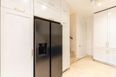 a stainless steel refrigerator in a kitchen with white cabinets at Luxury House in the heart of Cartagena with Jacuzzi in Cartagena de Indias
