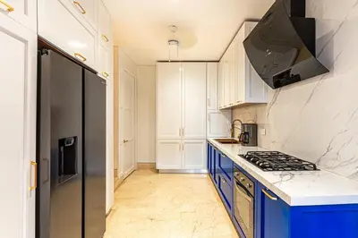 a kitchen with blue cabinets and a stove top oven at Luxury House in the heart of Cartagena with Jacuzzi in Cartagena de Indias