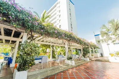 a pergola with flowers on it in front of a building at Paraíso By Elemnt Rentals in Santa Marta