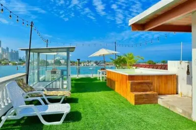 a patio with a table and chairs and the water at Hotel Capsula CAPS Cartagena in Cartagena de Indias