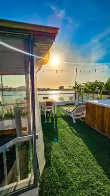 a patio with a view of the ocean and the sunset at Hotel Capsula CAPS Cartagena in Cartagena de Indias