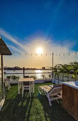 a patio with a table and chairs and a view of the water at Hotel Capsula CAPS Cartagena in Cartagena de Indias
