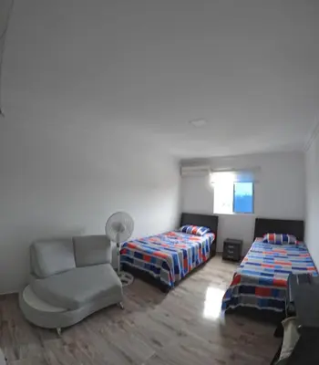 a bedroom with a bed and a couch and a chair at Viewpoint apartment near the Historic Center in Cartagena de Indias