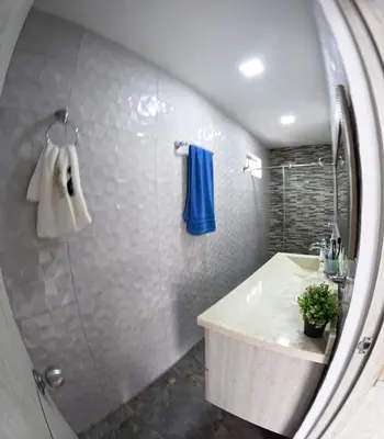 a bathroom with a shower and a sink and a mirror at Viewpoint apartment near the Historic Center in Cartagena de Indias