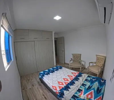 a bedroom with a bed in a small room at Viewpoint apartment near the Historic Center in Cartagena de Indias