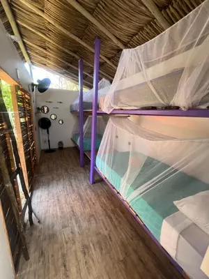 a bedroom with two bunk beds in a house at Riders Shared Room en Mojarra Beach in Salina de Rey