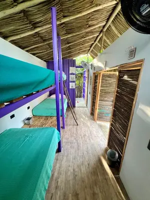 a room with two bunk beds and a wooden floor at Riders Shared Room en Mojarra Beach in Salina de Rey