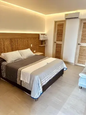 a bedroom with a large bed in a room at Mero Beach - Apartamento frente al mar en Tolú in San Silvestre