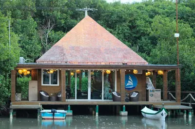 a small house on a dock on a body of water at Mero Beach - Apartamento frente al mar en Tolú in San Silvestre
