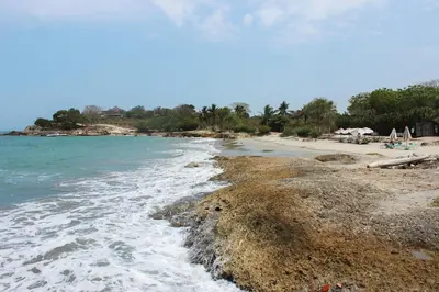 a beach with the water washing up on the shore at Suemar Cabaña de Playa en Isla de Tierra Bomba in Cartagena de Indias