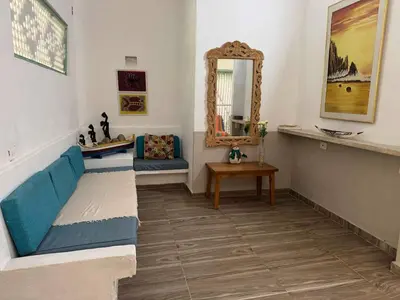 a living room with a blue couch and a mirror at Suemar Cabaña de Playa en Isla de Tierra Bomba in Cartagena de Indias