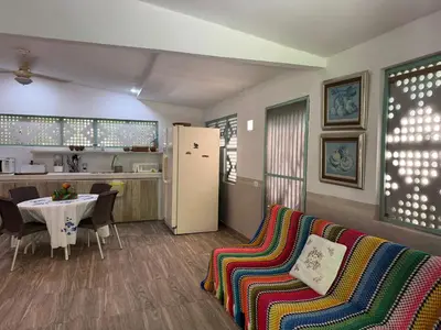 a living room with a couch and a table and a refrigerator at Suemar Cabaña de Playa en Isla de Tierra Bomba in Cartagena de Indias