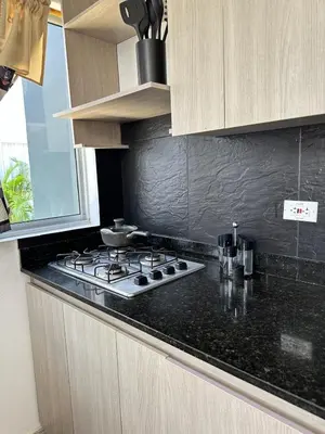 a kitchen with a stove and a counter top at Casa2 Duplex AC WiFi Piscina Acceso al mar in San Bernardo del Viento