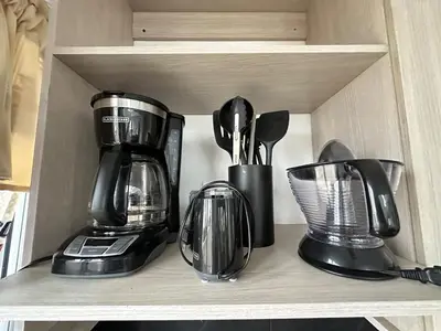 a shelf with a coffee maker and utensils on it at Casa2 Duplex AC WiFi Piscina Acceso al mar in San Bernardo del Viento